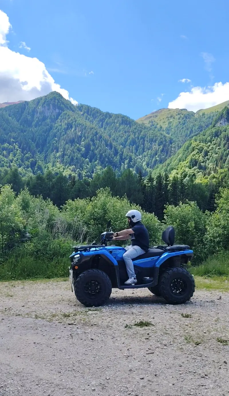 Blue ATV at a viewpoint on the Royal Sheepfold trail, view over the Bucegi