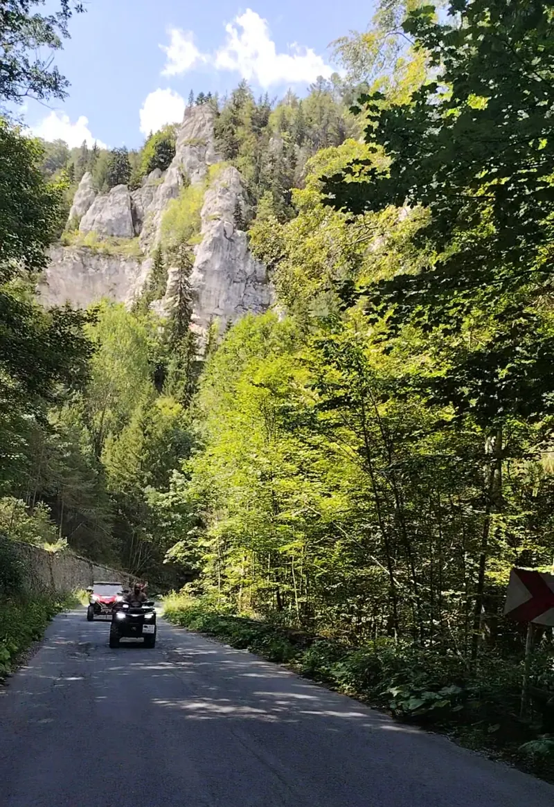 ATV on the Cota 1400 trail with rock formations overlooking Sinaia