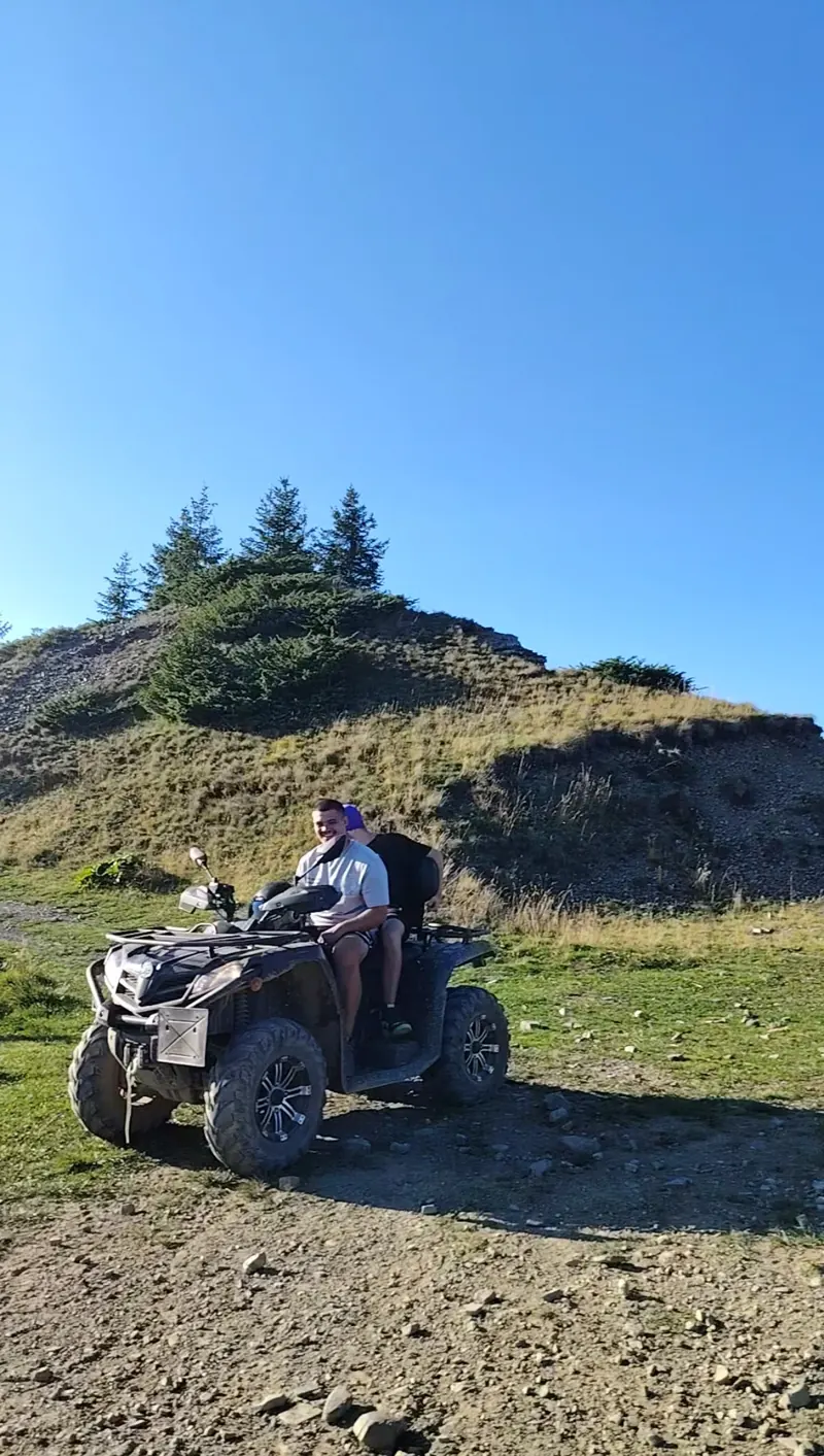 Two tourists on an ATV on the hills of the Baiu Mountains, Sinaia
