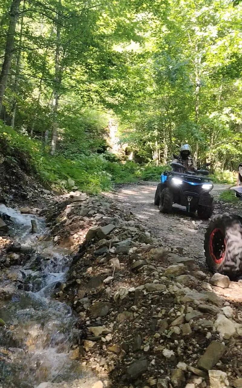 ATV splashing through mud on the Royal Sheepfold trail