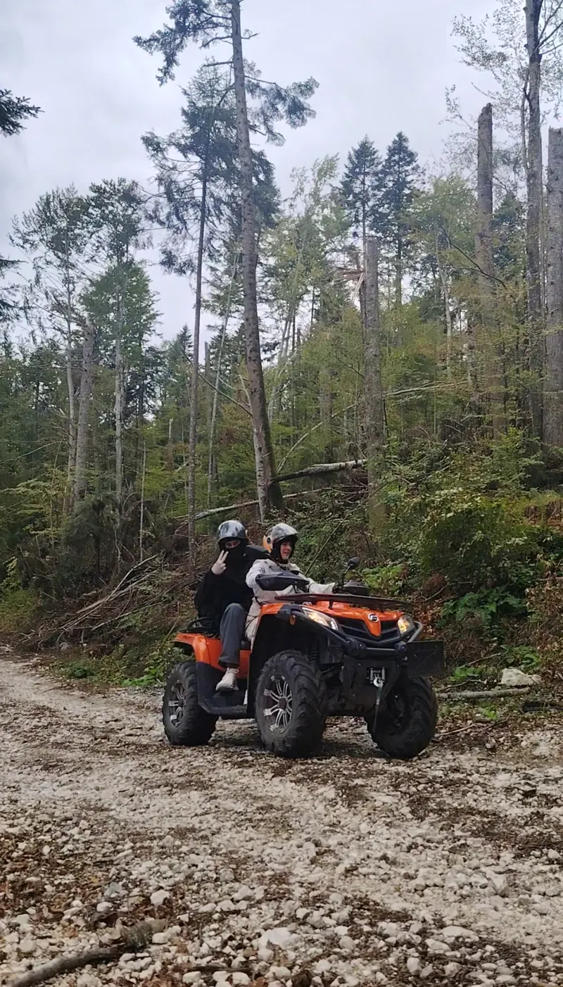 Orange ATV with two tourists on the combined trail in the Bucegi Mountains, Sinaia