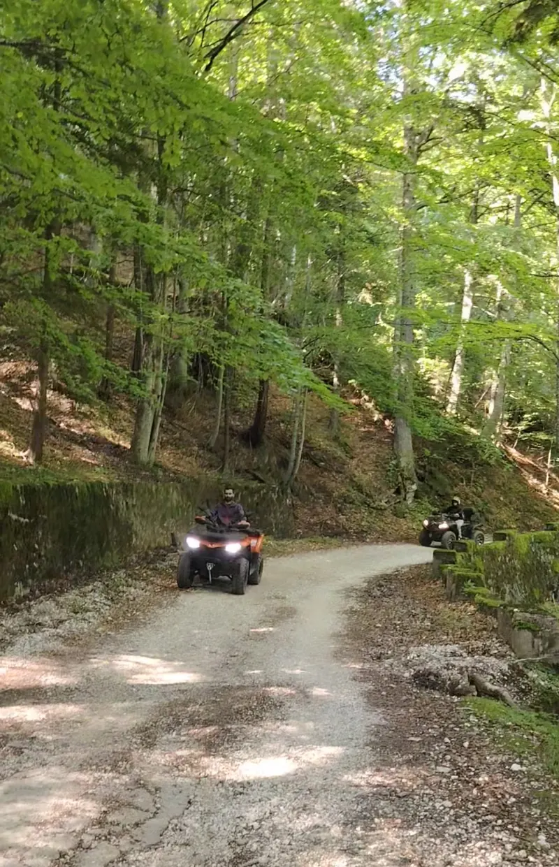 ATVs on the wide Forest Road through the Bucegi Mountains forest