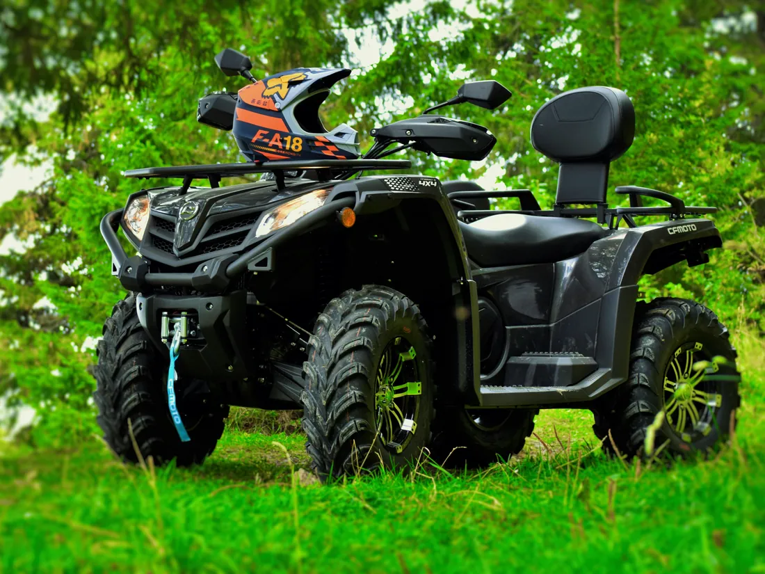 Black CFMOTO CFORCE 450 L ATV with helmet, available for rental in Sinaia
