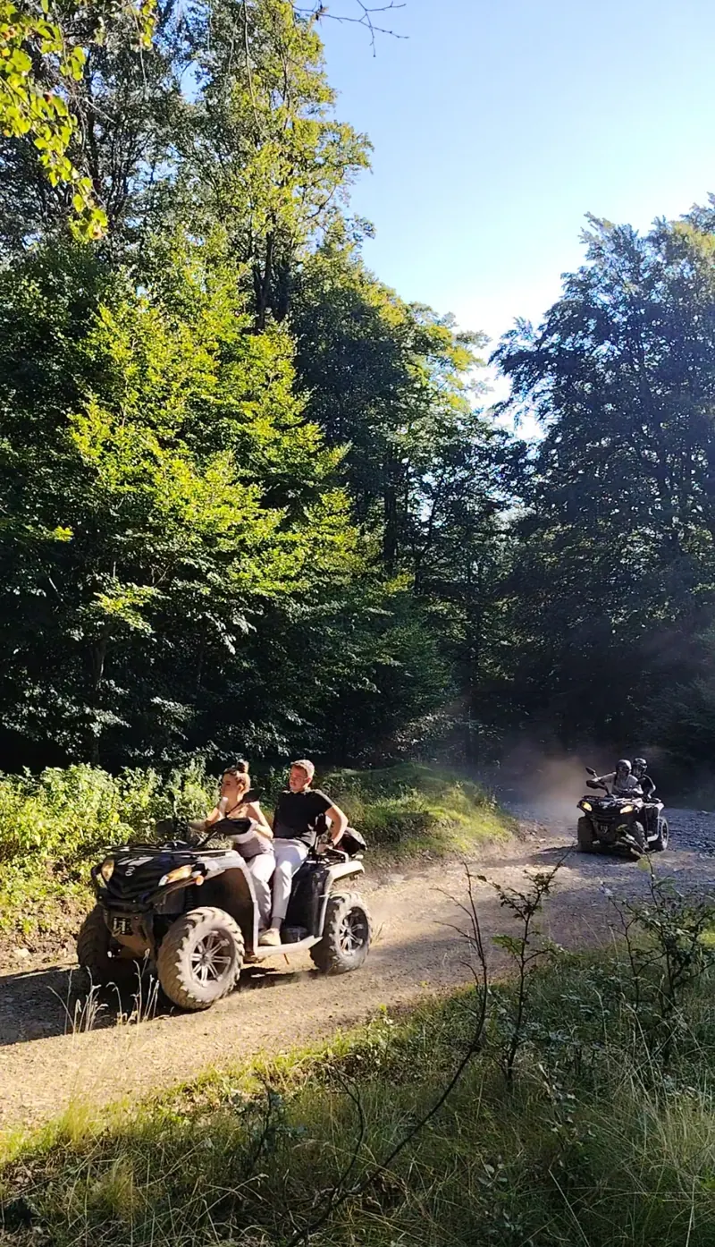 Column of ATVs on a meadow in the Baiu Mountains, off-road adventure Sinaia