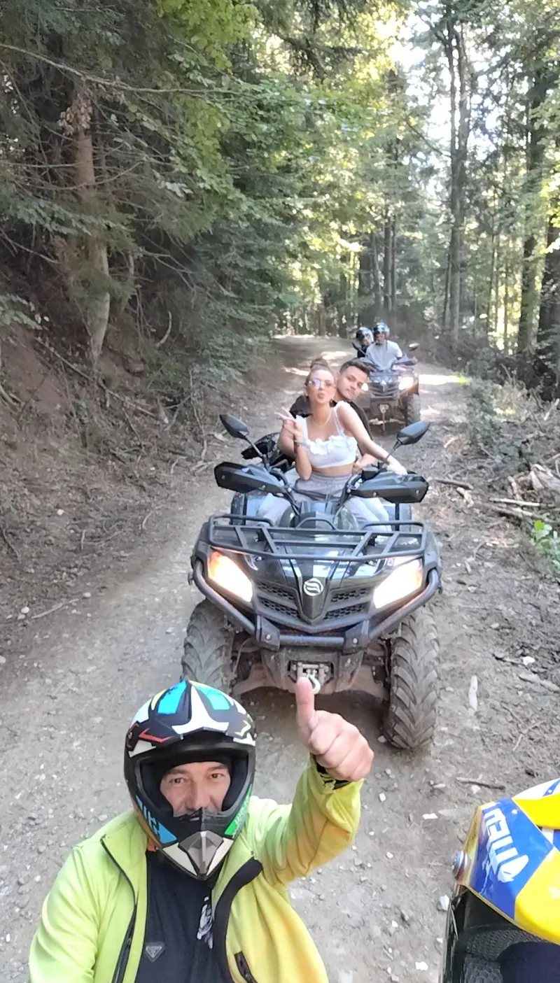 Group of tourists on ATVs on the Baiu Mountains ridge with panorama over the Bucegi